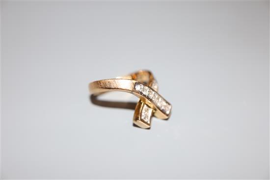 A modern 585 yellow metal and diamond set X ring, size H, gross 4.3 grams.